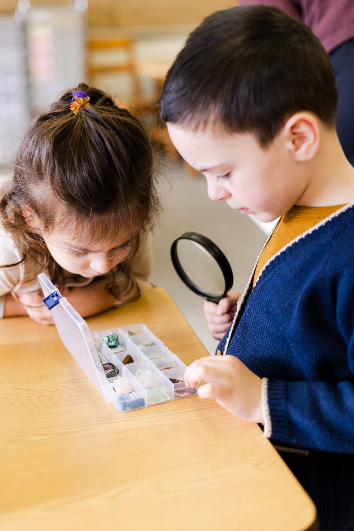 St. Ambrose students using magnifying glass