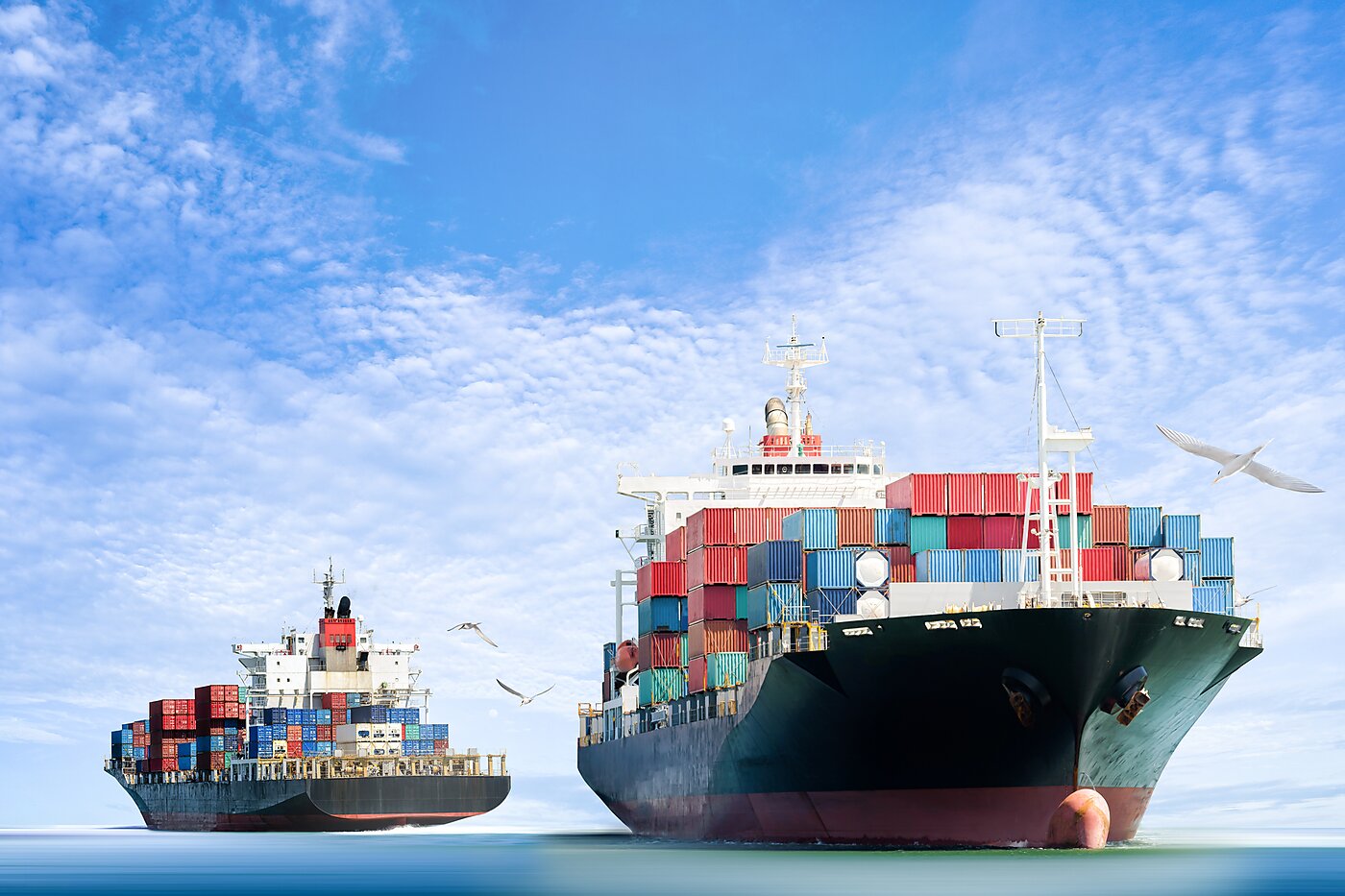 Cargo ships against a blue sky