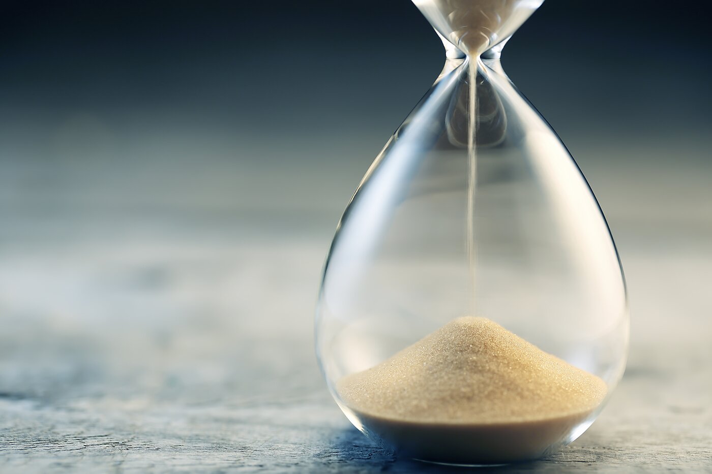 sand falls through an hourglass